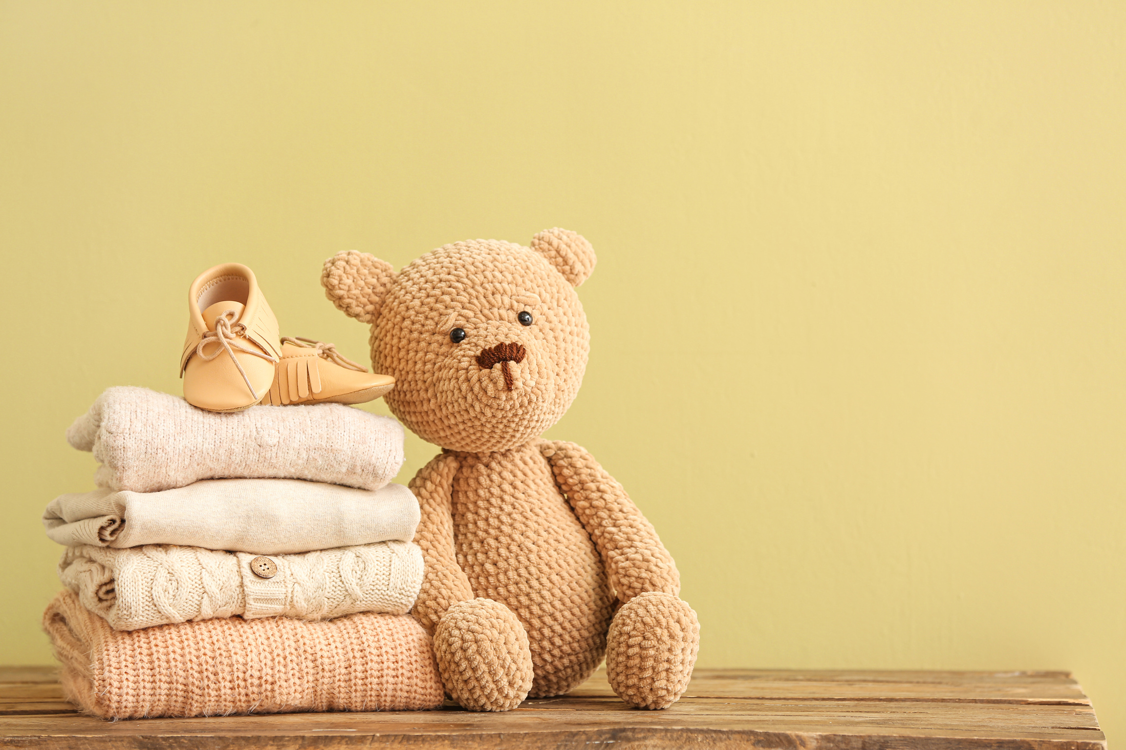 Stack of Baby Clothes and Toy 